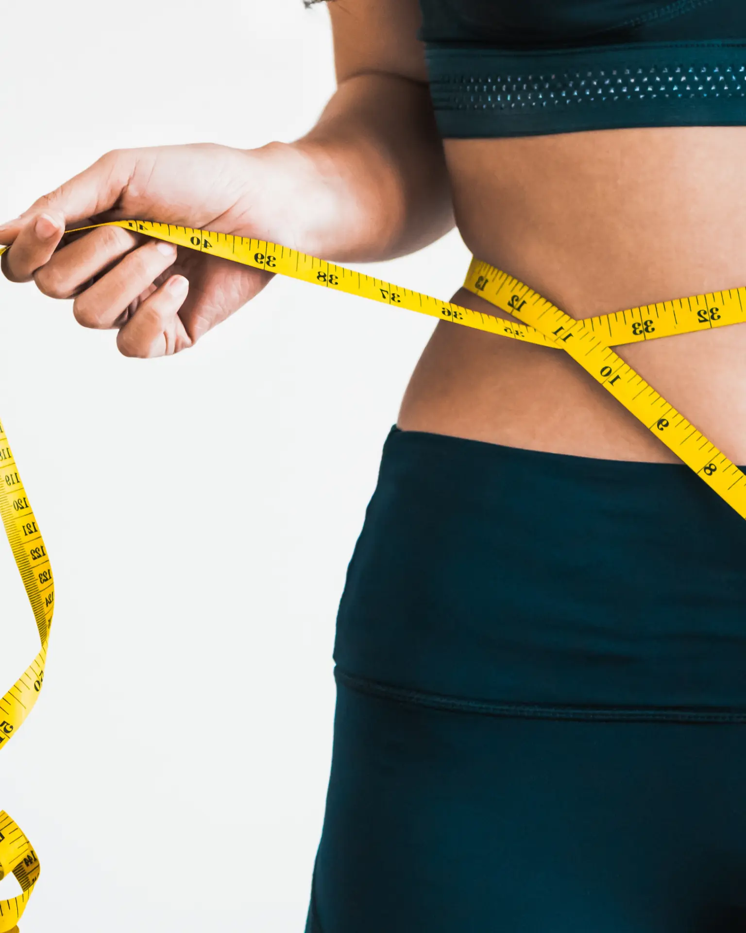 Waist being measured with a tape measure