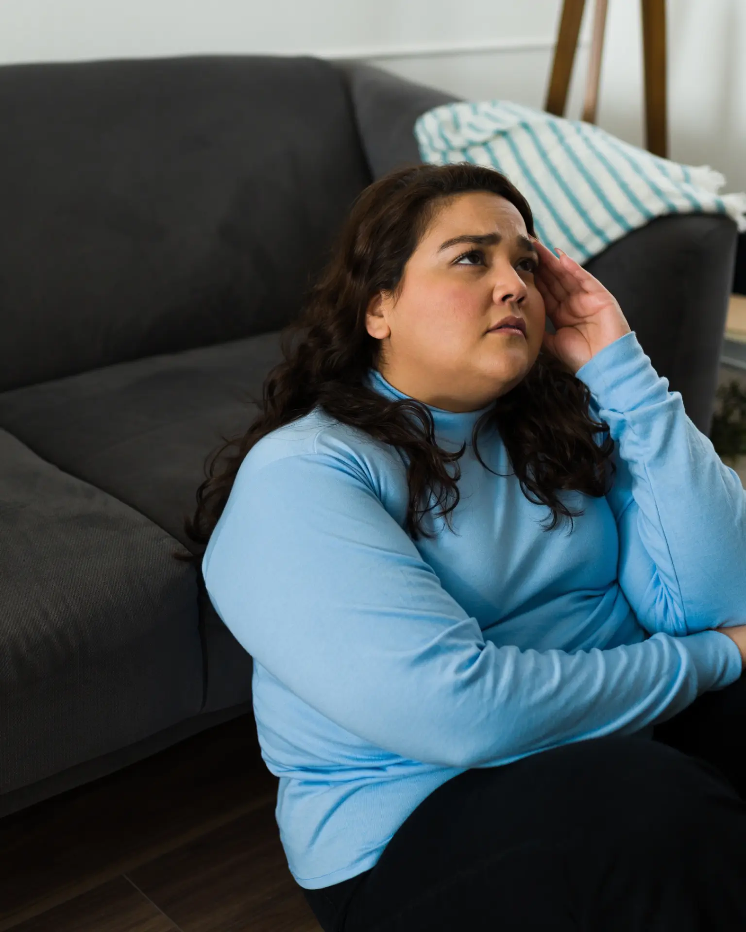 Woman sitting at home, worn out